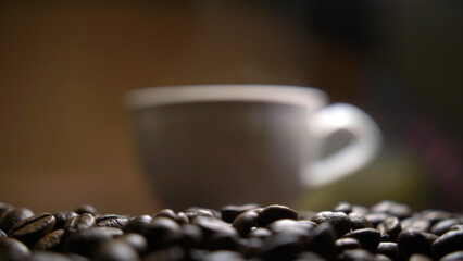 cup with hot coffee stands on coffee beans, have fun and enjoy © vla