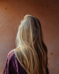 Fototapeta premium Rear View of Woman with Long Blonde Hair Standing in Soft Window Light for Salon Branding and Hair Health Campaign Background with Copy Space
