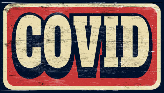 Aged and worn covid sign on wood