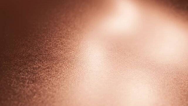Abstract rose gold copper metallic texture background with soft light reflections and shimmer.