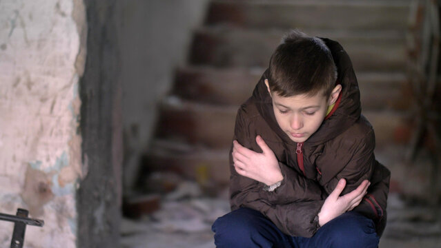 boy freezing in warm clothing in a dilapidated old house, have fun and enjoy
