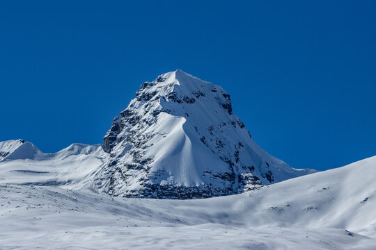 Dramatic close-up of the pyramid peak of Sapu Mountain with clean snow ridges, Tibet