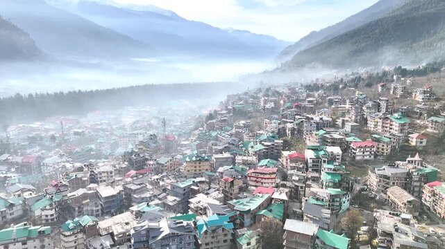Aerial view of a city based next to a mountain