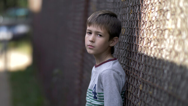 lonely boy looks into the camera with pain on face, regret for action, have fun and enjoy