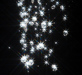Obraz premium Shining water created sparkling splash with bright reflections and starburst flare, like star in light. Water Glitter from splash caught light, creating abstract sparkling scene with star flare