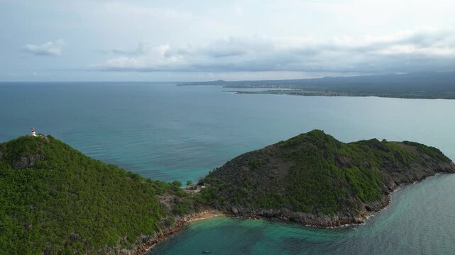 Aerial tracking shot in front of a Lighthouse and Ilh&eacute;u das Cabras, Sao Tome
