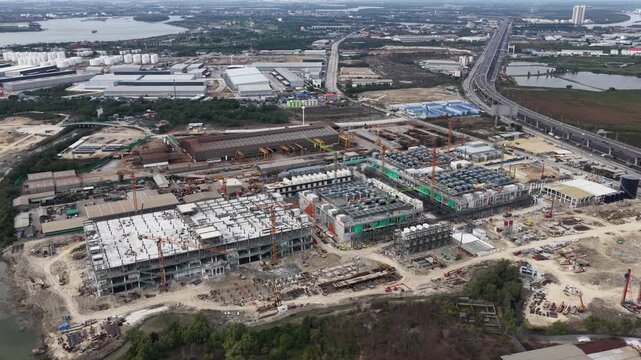 Aerial drone video of Data Centre QHI01 hyperscale campus construction in Chonburi, Thailand, within the Eastern Economic Corridor, showing large scale cloud computing, AI infrastructure, and