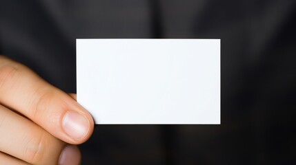 Obraz premium Hand holding a blank white business card closeup