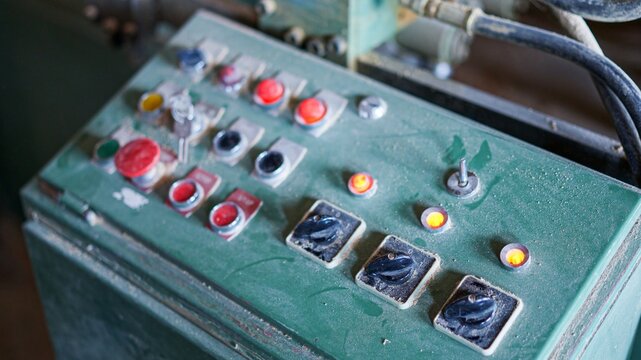 Old industrial machinery control panel with buttons and switches