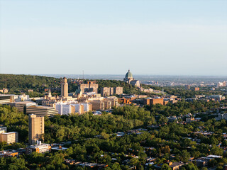 Fototapeta premium Aerial view of Universite de Montreal campus and Outremont district surrounded by forested Mount Royal at sunset, Montreal Canada. g.