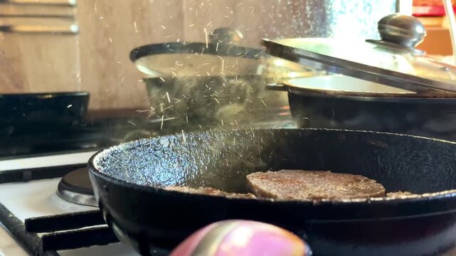 Close-up boiling oil background with meat are fried in a frying pan in boiling oil, olive oil texture. High quality 4k
