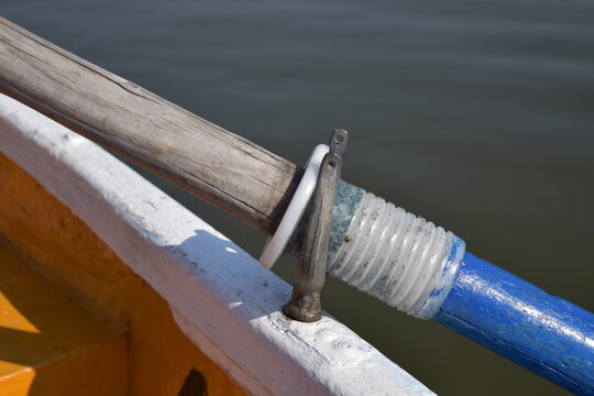 Close Up of Wooden Oar and Rowlock on White Boat