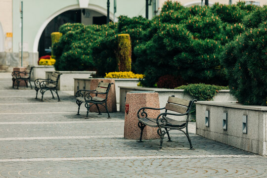 Public benches on central square of old town in Europe for citizens to rest