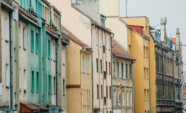 Eastern Europe 19th century houses, crumbling facade, cracked plaster and paint, neglected old town center.