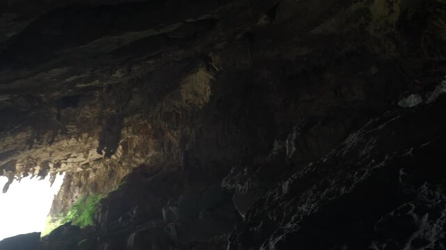 Panning right to left from the interior of Nam Non Cave to show the entrance and high ceilings of the cave.
