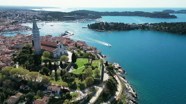 Aerial drone footage of Rovinj, Croatia: historic old town, Adriatic coastline and iconic church skyline. Ideal for travel, tourism and Mediterranean city projects.