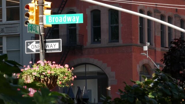 New York City Broadway street sign on Manhattan, United States. Urban road sign in american city. Traffic sign in Midtown. Building architecture in Flatiron district. Crossroad with 5 fifth avenue.