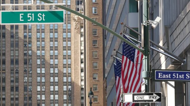 New York City Park Avenue, street sign in Manhattan Midtown, United States. Urban road sign, traffic sign in NYC, USA. Building architecture near Grand Central. One way arrow and American flag.