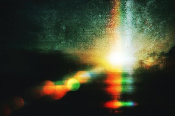 Fototapeta premium A vibrant, abstract image features a bright, central light source surrounded by blurred colors and a textured, grainy surface, creating a sense of dynamic energy and visual complexity.