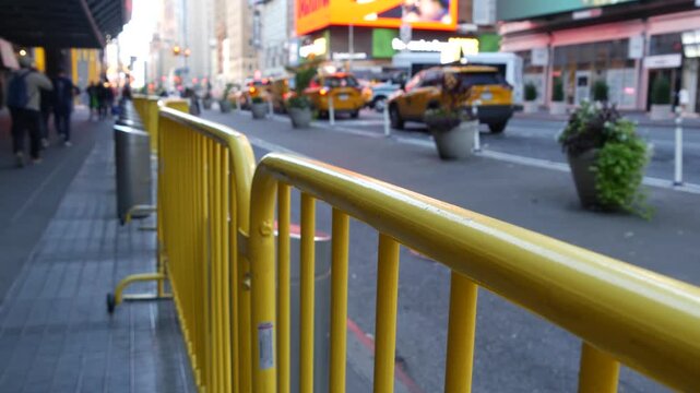 Manhattan Midtown street New York City, United States. Port authority bus terminal. Defocused car traffic on urban road, 8th avenue in Hells Kitchen. People pedestrian, yellow taxi. Sidewalk pavement.