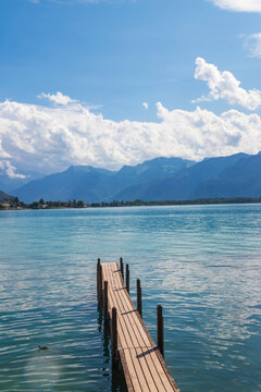 Wooden pier overlooking the Swiss Alps and Lake Geneva in Switzerland