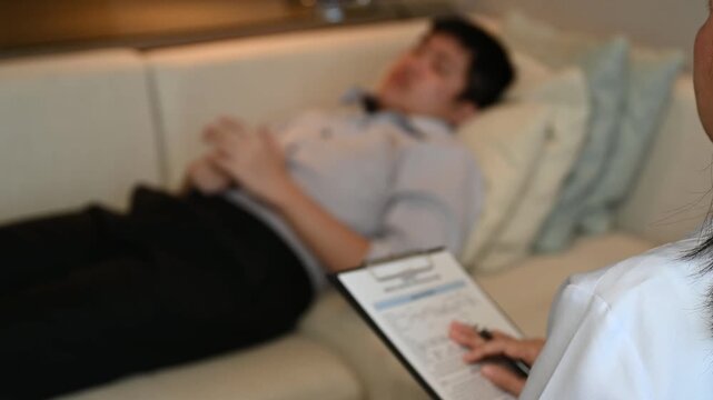 Psychiatrist doctor or psychologist talking and psychology question with patient for mental health assessment.