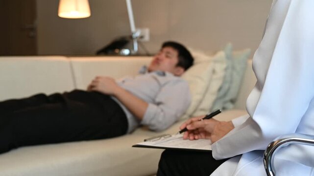 Psychiatrist doctor or psychologist talking and psychology question with patient for mental health assessment.