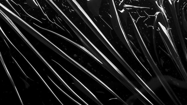 transparent plastic film wrap overlay texture on black background stop motion