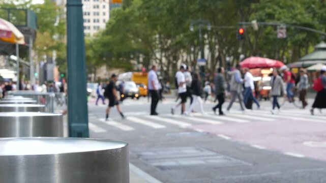 Sixth 6 avenue and 42nd street crossroad, Bryant park in Manhattan Midtown, New York City, United States of America. Defocused people pedestrians crossing on zebra near bank, yellow taxi car on road.