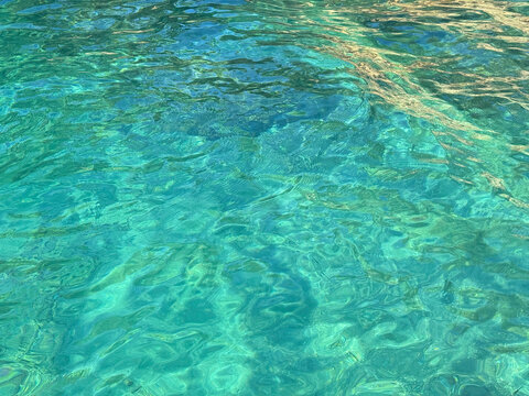 Blue clear sea rippling water background.