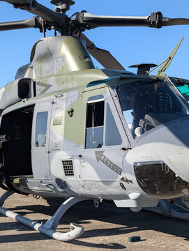Camouflage Military Utility Helicopter Against Blue Sky