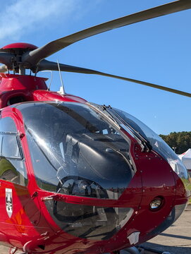 Sleek Red H135 Helicopter Rotor and Canopy