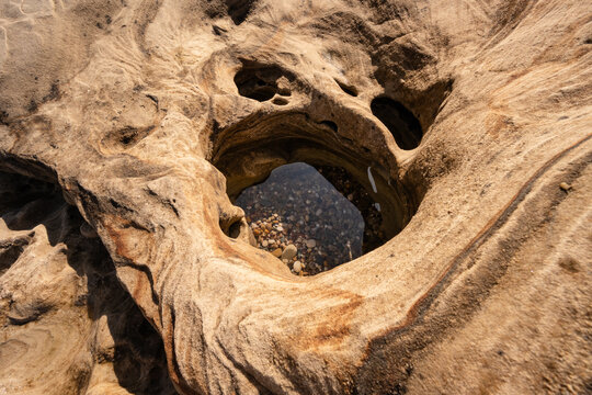 Sandstone rock formation creating natural coastal tide pools