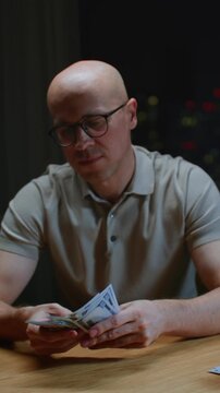 Closeup vertical: man hands counting dollar cash banknotes. Caucasian male calculates his income, salary, profit. Making USD currency money, success, wealth concept, make money.