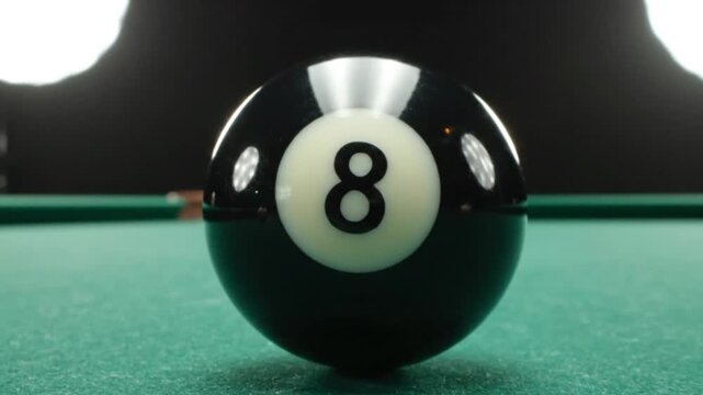 Macro Close-up of 8-Ball Rolling into Focus on Green Billiard Table