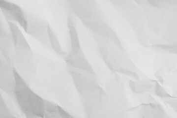 Obraz premium Top view of white crumpled paper texture background,Macro,Close-up shot of white wrinkled and crumpled paper texture background. High resolution texture of folded paper with shadows and highlights,