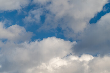 Fototapeta premium Clear sky scene. Calm morning scene with bright sky and wispy clouds. Vivid blue sky with fluffy clouds and warm sunlight creating soothing atmosphere for various uses