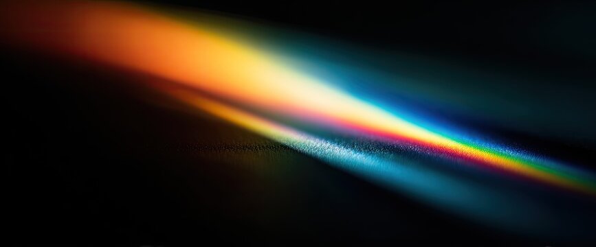A vibrant, abstract image showcases a spectrum of refracted light, creating a dynamic and colorful visual effect against a dark background.