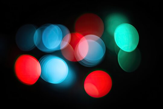 A vibrant display of blurred, circular lights against a dark background creates an ethereal and captivating visual effect.