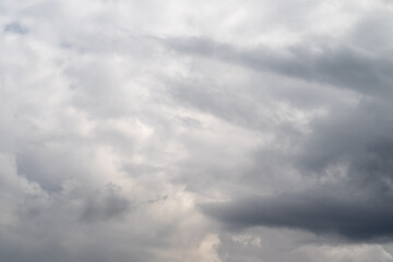 Obraz premium Somber overcast atmosphere. Dark clouds obscure faint light. Gloomy sky veiled by thick cloud cover. Ominous overcast sky concealed beneath dense layers of clouds