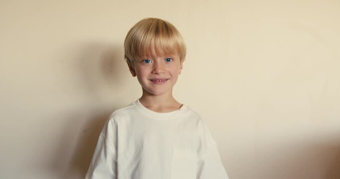 Shot of a little boy jokingly picking his nose with his finger and laughing. Childish fun.