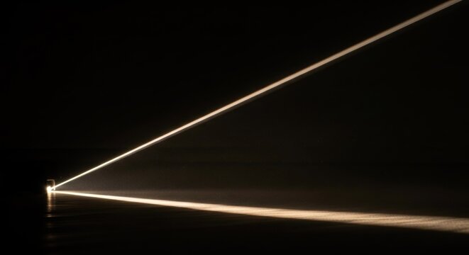 A long exposure photograph of a single beam of light shining through a window, creating a series of parallel lines and streaks of light on a dark background.