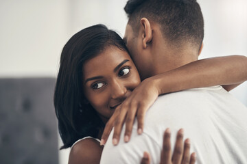 Obraz premium Love, couple or hug in home for trust, care or healthy relationship with partner for loyalty. Connection, man and woman embrace in apartment with commitment, support or bonding together with security