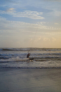 Kitesurfer riding at sunset on Batu Bolong Beach, Canggu, Bali