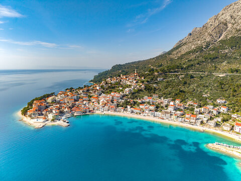 Makarska riviera. Aerial view of a small coastal town Igrane on the Adriatic coastline. Residential buildings and a beach with clear turquoise water