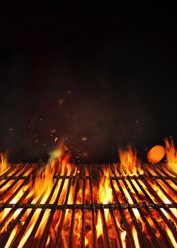Fire embers particles over black background.  Grill Background - Empty Fired Barbecue On Black . Abstract dark glitter fire particles lights. Poster with copy space.