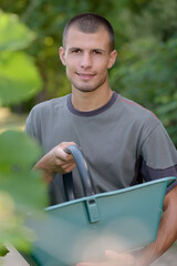 Fototapeta premium portrait of young grape harvester holding trug