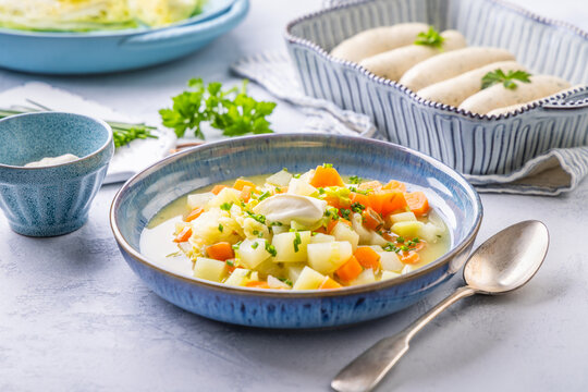Fresh homemade vegetable soup with white sausages as side dish