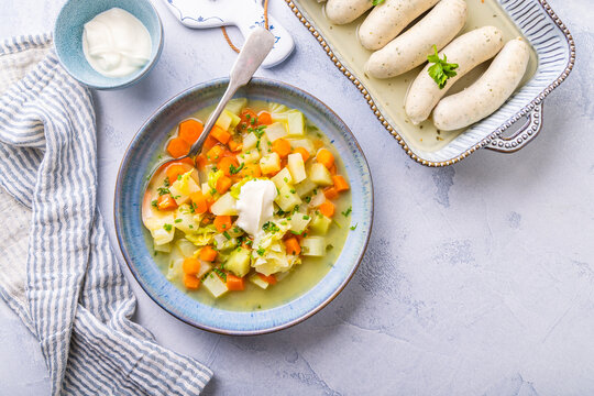 Fresh homemade vegetable soup with white sausages as side dish