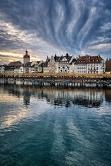 Obraz premium Beautiful European city waterfront with reflections and dramatic cloudy sky